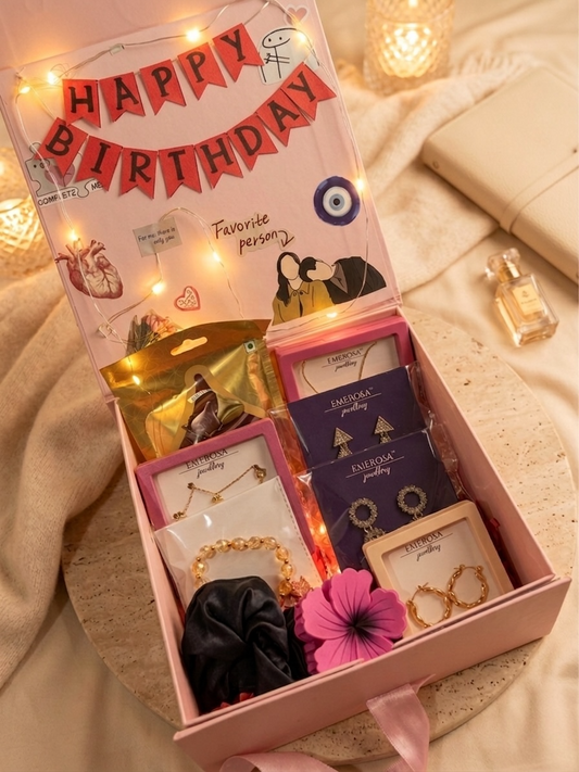 Gift box with jewelry and decorative items on a soft surface