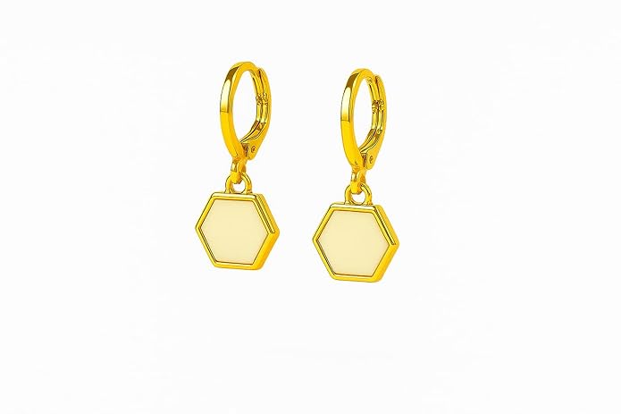 Pair of gold hexagonal earrings on a white background