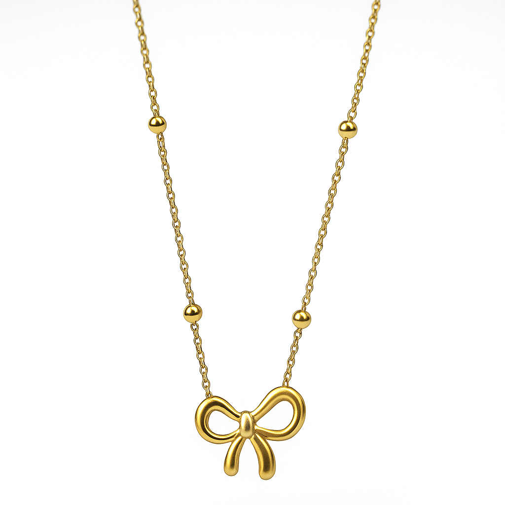 Gold bow-shaped pendant necklace on a white background