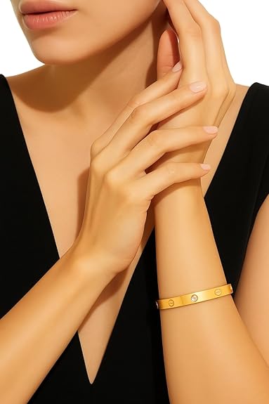 Gold bracelet on a person's wrist with a blurred background
